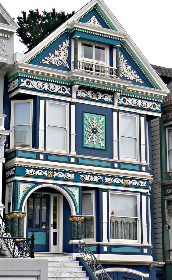 Modern Victorian home exterior with blue color and unique pattern