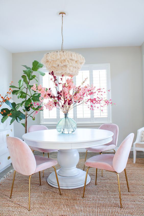 White round dining table with soft pink dining chairs