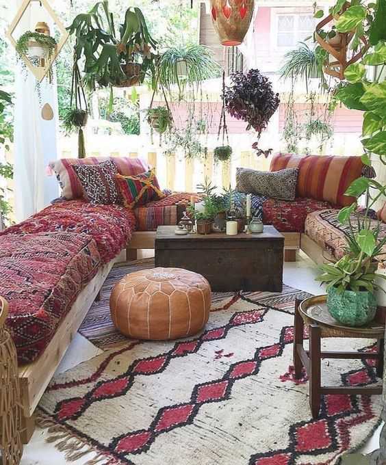 Maroon sofa and some hanging plants